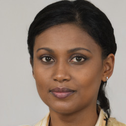 Joyful black young-adult female with medium  brown hair and brown eyes