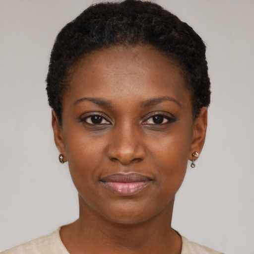 Joyful black young-adult female with short  black hair and brown eyes