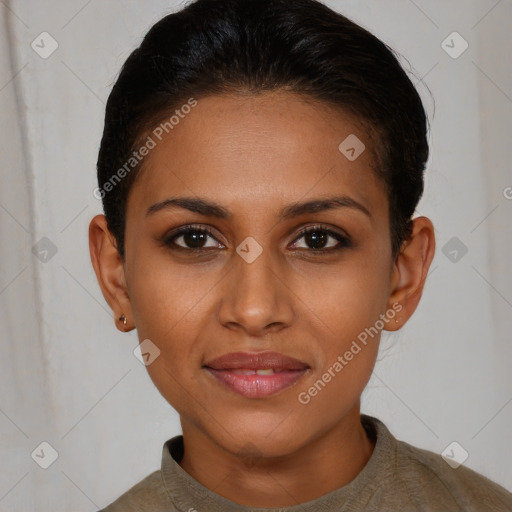 Joyful black young-adult female with short  brown hair and brown eyes