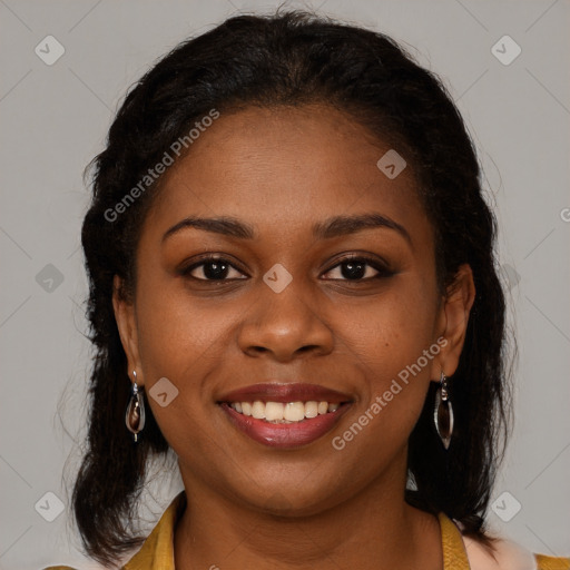 Joyful black young-adult female with long  brown hair and brown eyes