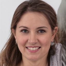 Joyful white young-adult female with long  brown hair and grey eyes