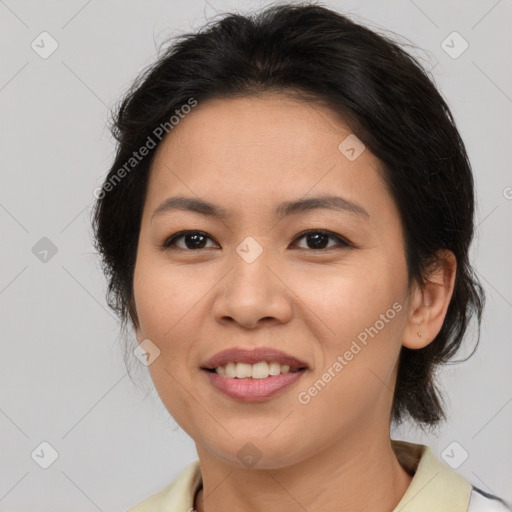 Joyful asian adult female with medium  brown hair and brown eyes