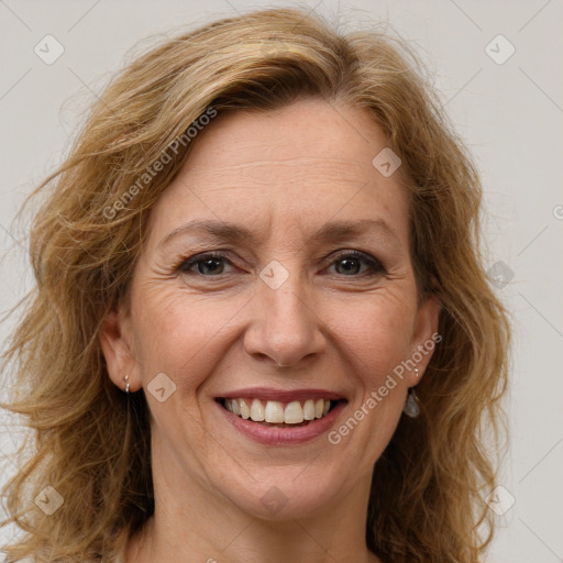 Joyful white adult female with long  brown hair and brown eyes