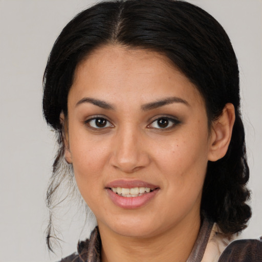 Joyful latino young-adult female with long  brown hair and brown eyes