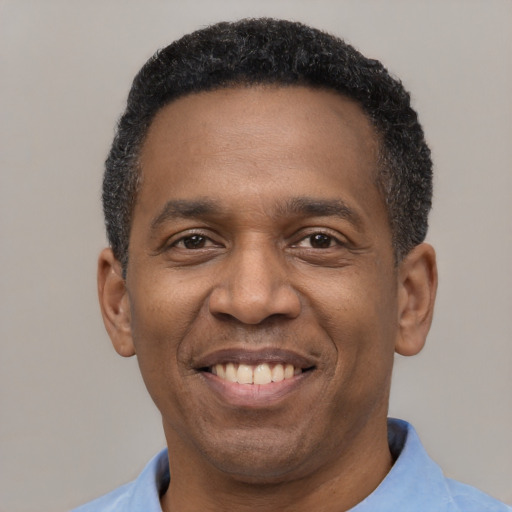 Joyful latino adult male with short  black hair and brown eyes