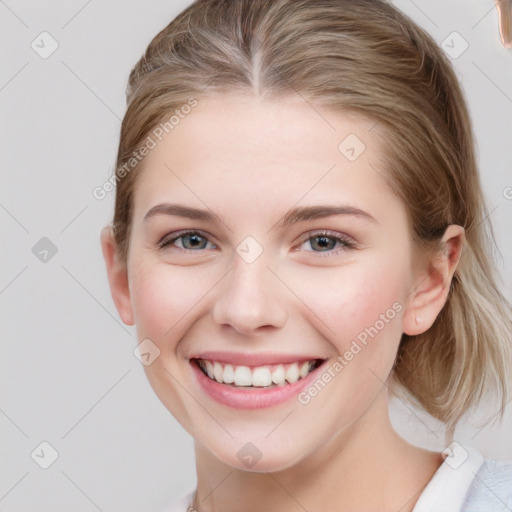 Joyful white young-adult female with medium  brown hair and blue eyes