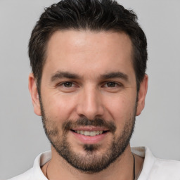 Joyful white young-adult male with short  brown hair and brown eyes