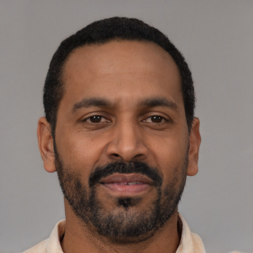 Neutral latino adult male with short  black hair and brown eyes