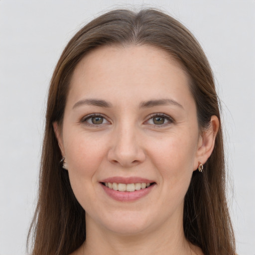 Joyful white young-adult female with long  brown hair and grey eyes