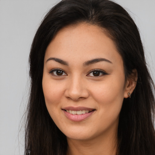 Joyful asian young-adult female with long  brown hair and brown eyes