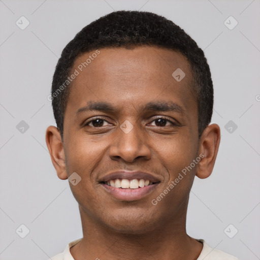 Joyful black young-adult male with short  black hair and brown eyes