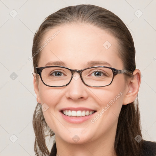 Joyful white young-adult female with long  brown hair and blue eyes