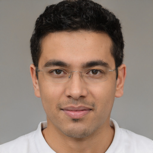 Joyful latino young-adult male with short  black hair and brown eyes
