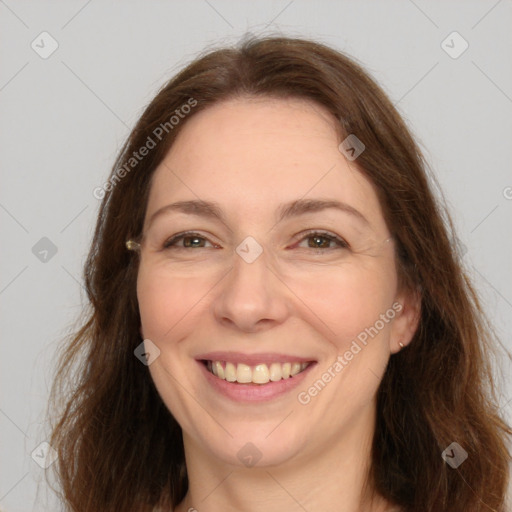 Joyful white adult female with long  brown hair and brown eyes