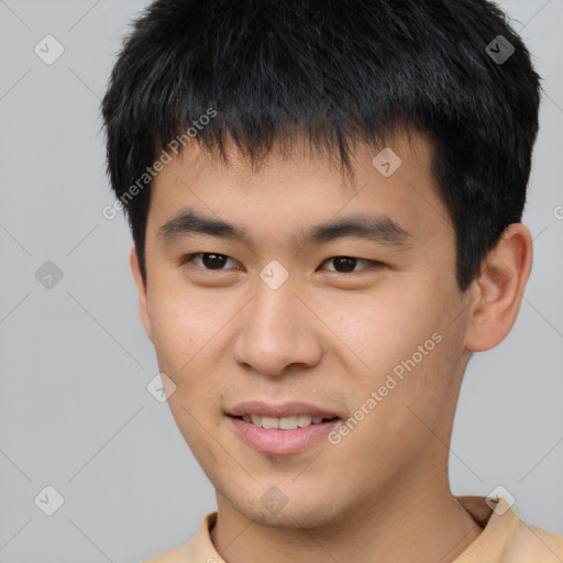 Joyful asian young-adult male with short  black hair and brown eyes