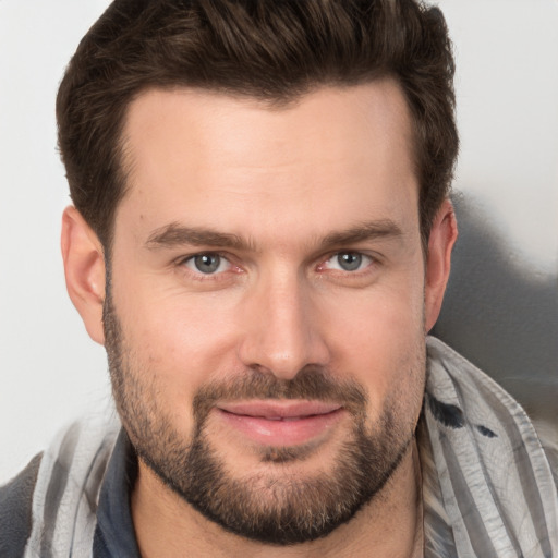 Joyful white young-adult male with short  brown hair and brown eyes