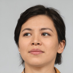 Joyful asian young-adult female with medium  brown hair and brown eyes