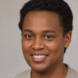 Joyful black young-adult male with short  brown hair and brown eyes