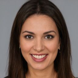 Joyful white young-adult female with long  brown hair and brown eyes