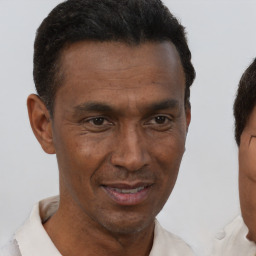 Joyful black adult male with short  brown hair and brown eyes