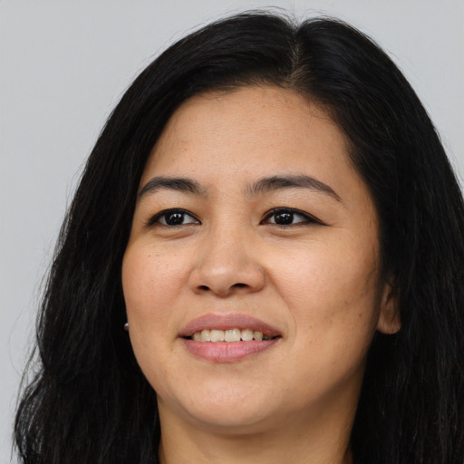 Joyful asian young-adult female with long  black hair and brown eyes