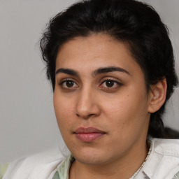 Joyful latino young-adult female with medium  brown hair and brown eyes