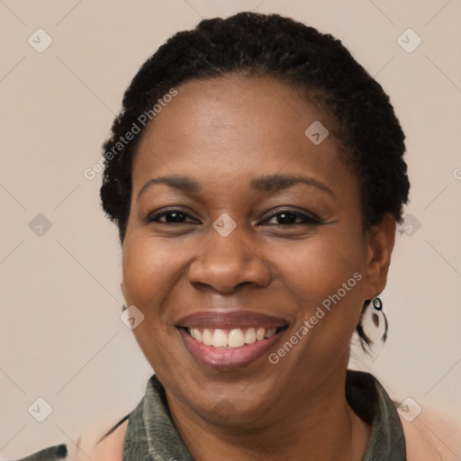 Joyful black adult female with short  brown hair and brown eyes