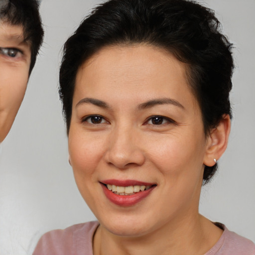 Joyful asian young-adult female with short  brown hair and brown eyes