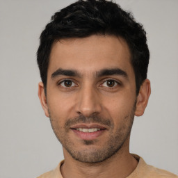 Joyful white young-adult male with short  black hair and brown eyes