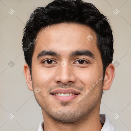 Joyful latino young-adult male with short  black hair and brown eyes