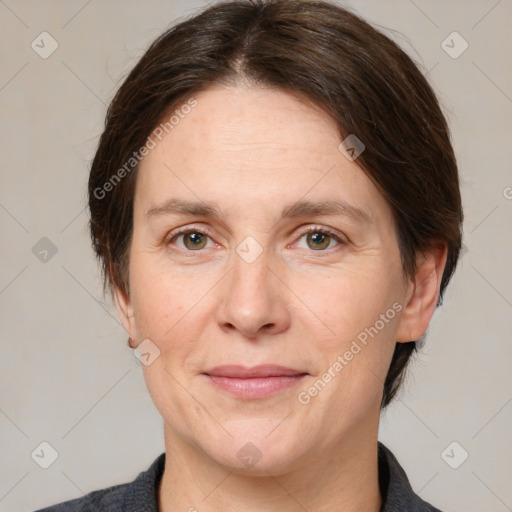 Joyful white adult female with medium  brown hair and grey eyes