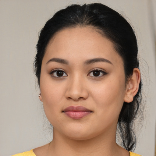 Joyful latino young-adult female with medium  black hair and brown eyes