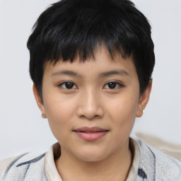 Joyful asian child male with short  brown hair and brown eyes