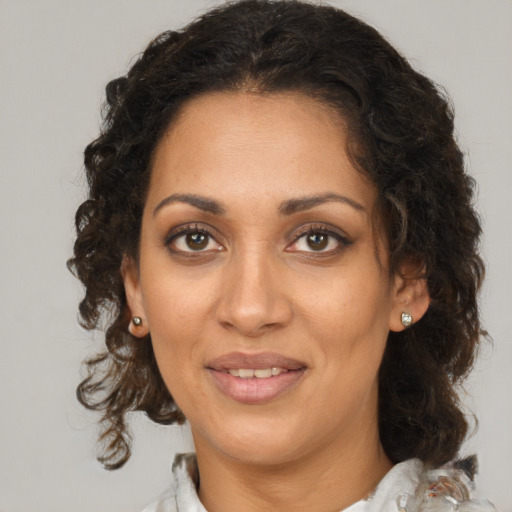 Joyful black young-adult female with medium  brown hair and brown eyes