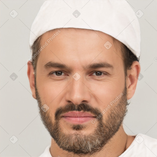 Joyful white adult male with short  black hair and brown eyes