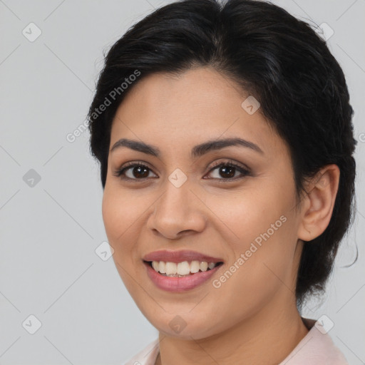 Joyful latino young-adult female with medium  brown hair and brown eyes