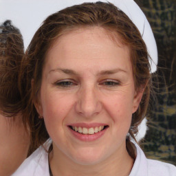 Joyful white adult female with medium  brown hair and brown eyes