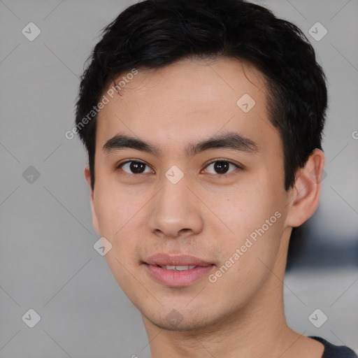 Joyful asian young-adult male with short  black hair and brown eyes