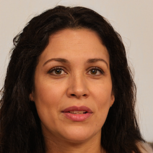 Joyful white adult female with long  brown hair and brown eyes