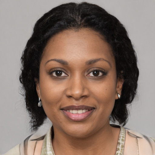 Joyful black young-adult female with medium  black hair and brown eyes