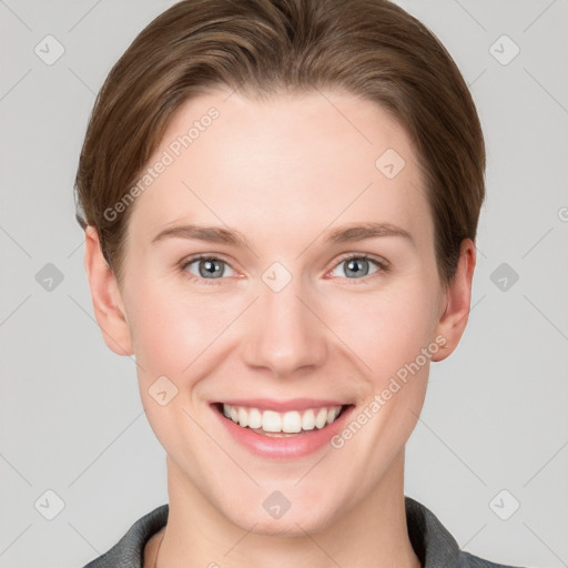 Joyful white young-adult female with short  brown hair and grey eyes