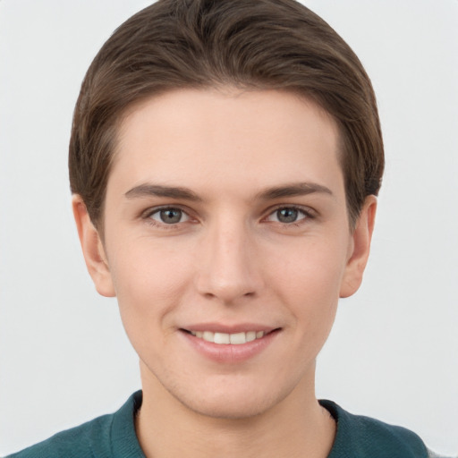 Joyful white young-adult female with short  brown hair and grey eyes