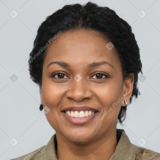 Joyful black adult female with short  brown hair and brown eyes