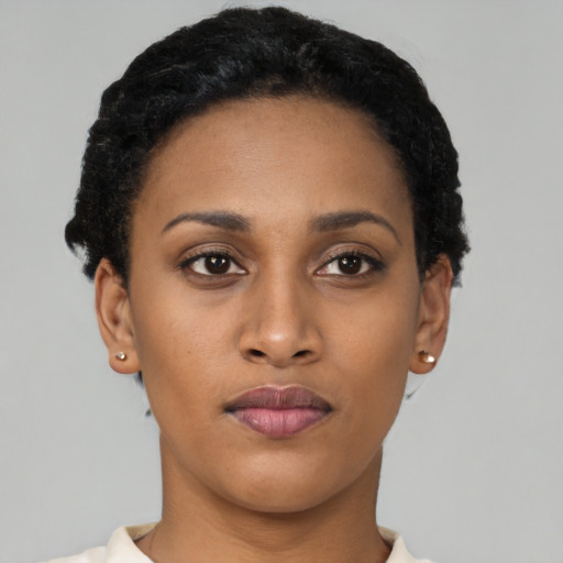 Joyful latino young-adult female with short  black hair and brown eyes