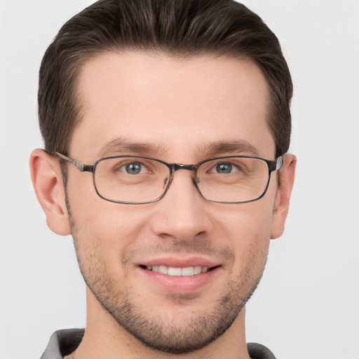 Joyful white young-adult male with short  brown hair and brown eyes