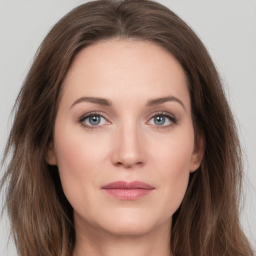 Joyful white young-adult female with long  brown hair and grey eyes