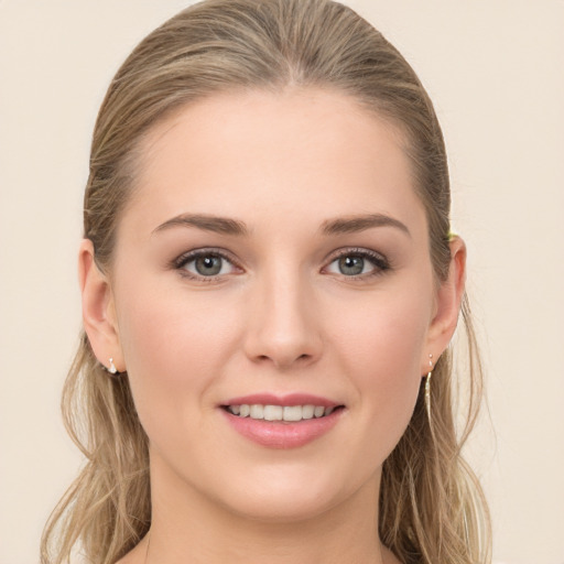 Joyful white young-adult female with long  brown hair and blue eyes