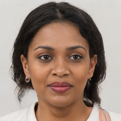 Joyful black young-adult female with medium  brown hair and brown eyes