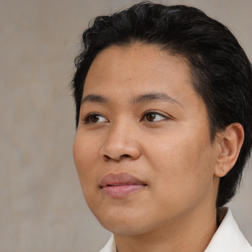 Joyful asian young-adult female with short  black hair and brown eyes