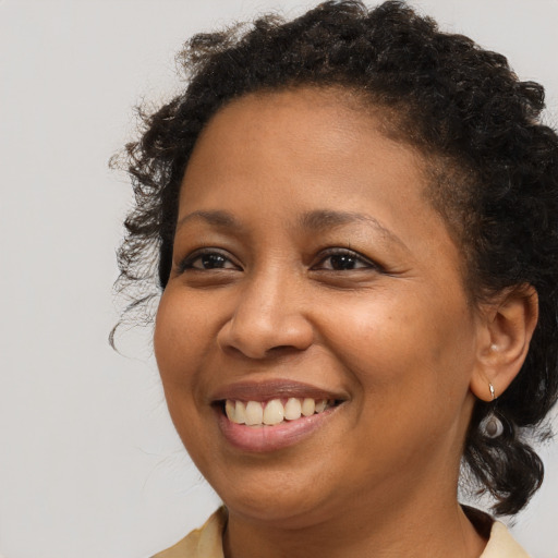 Joyful black young-adult female with medium  brown hair and brown eyes